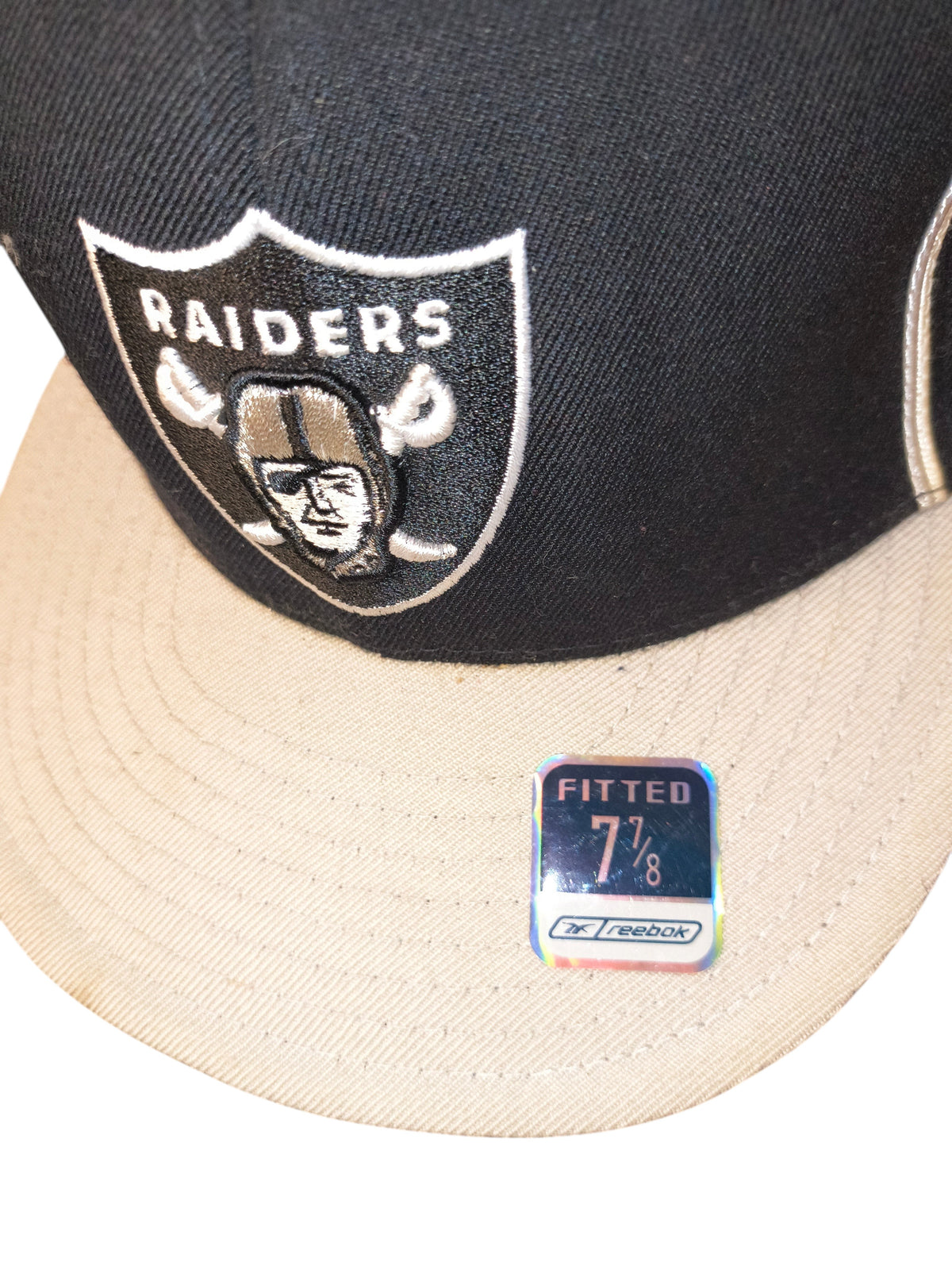 Awsum Thrift vintage Reebok Raiders fitted hat with black crown, grey visor, and original holographic size sticker.