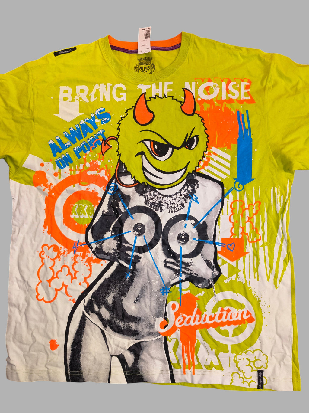 Awsum Thrift Akademiks lime green graphic tee featuring a devil pin-up design with orange collar and graffiti art.