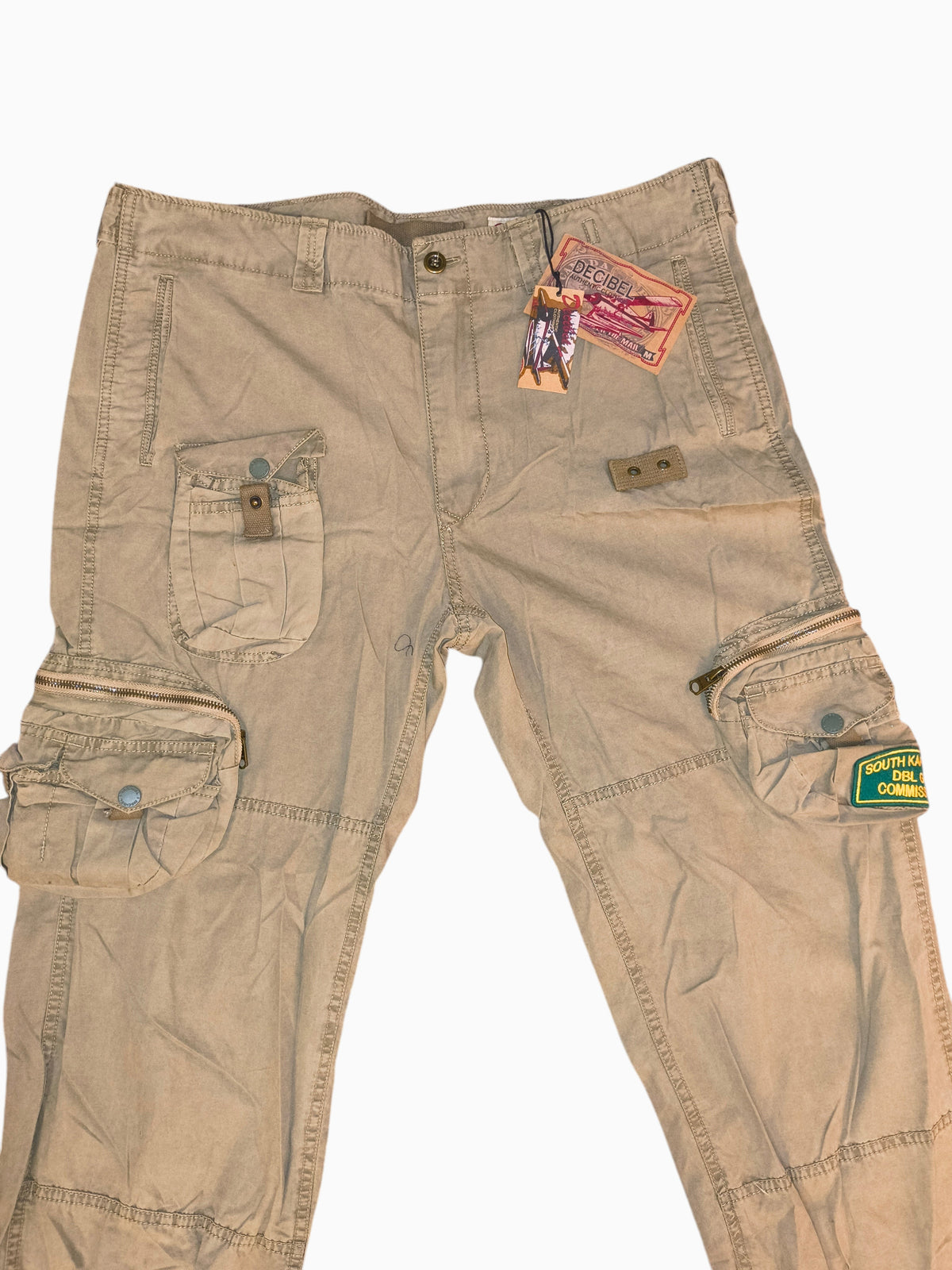 Awsum Thrift Decibel khaki tan cotton canvas tactical cargo pants with multi-pocket utility design and branded patches.
