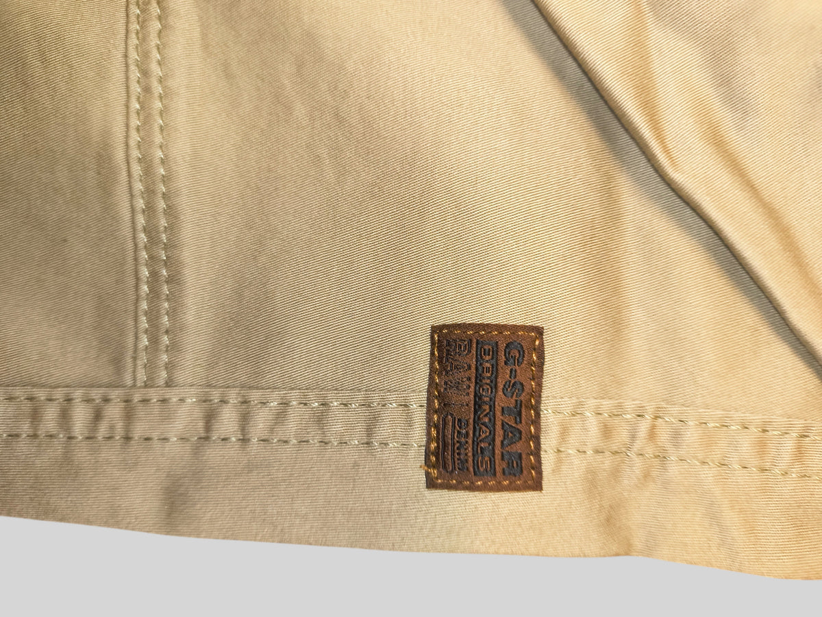 Awsum Thrift G-Raw pants in beige cotton twill with a brown leather G-Star Originals brand patch and stitched seams.