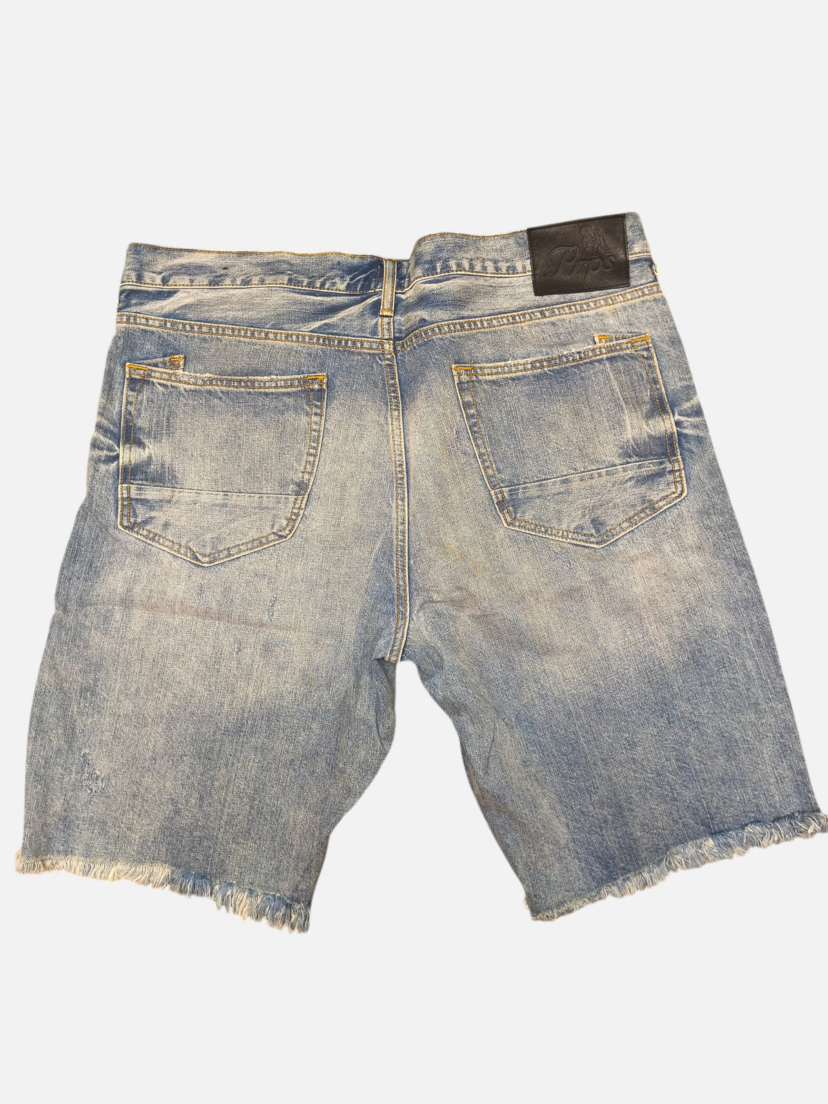 Awsum Thrift PRPS blue denim shorts with a distressed frayed hem and black leather back patch