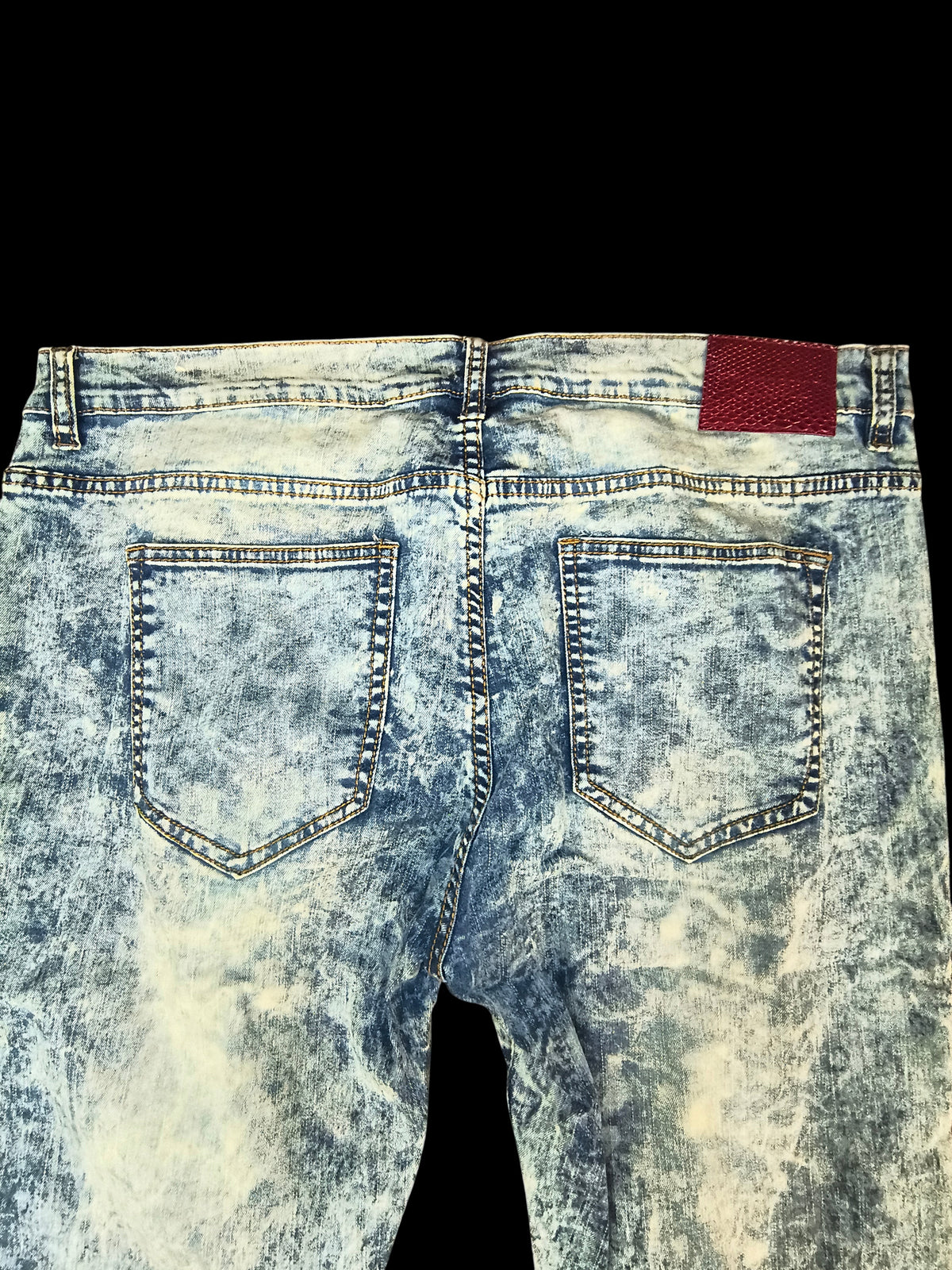 Awsum Thrift Scout Denim light ice-blue acid wash jeans with a red snakeskin-embossed back patch, back view.