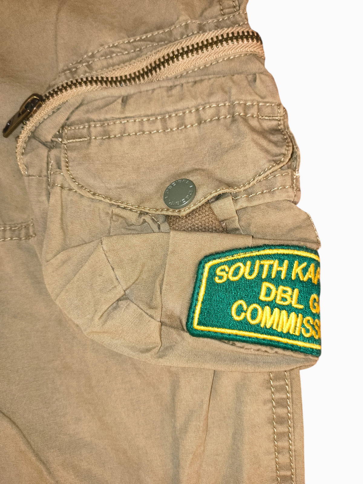 Awsum Thrift Decibel khaki cotton canvas tactical cargo pants with South Kapiti Plains patch and utility zipper pocket