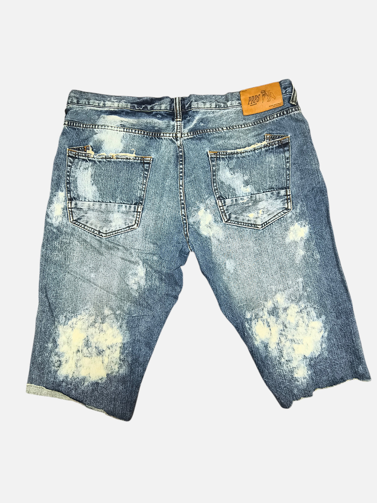 Awsum Thrift PRPS denim shorts in distressed blue wash with bleach splatter effect and raw hem back view