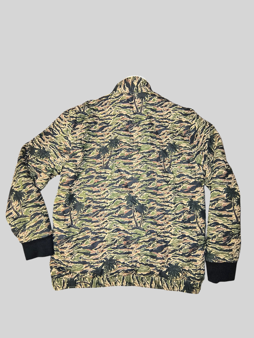 Awsum Thrift The Hundreds tiger palms camo bomber jacket with black ribbed cuffs and hem, back view.