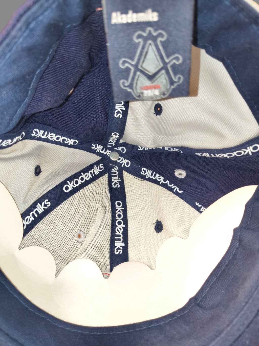 Awsum Thrift vintage Akademiks fitted hat interior showing branded taping and size tag in navy and grey fabric