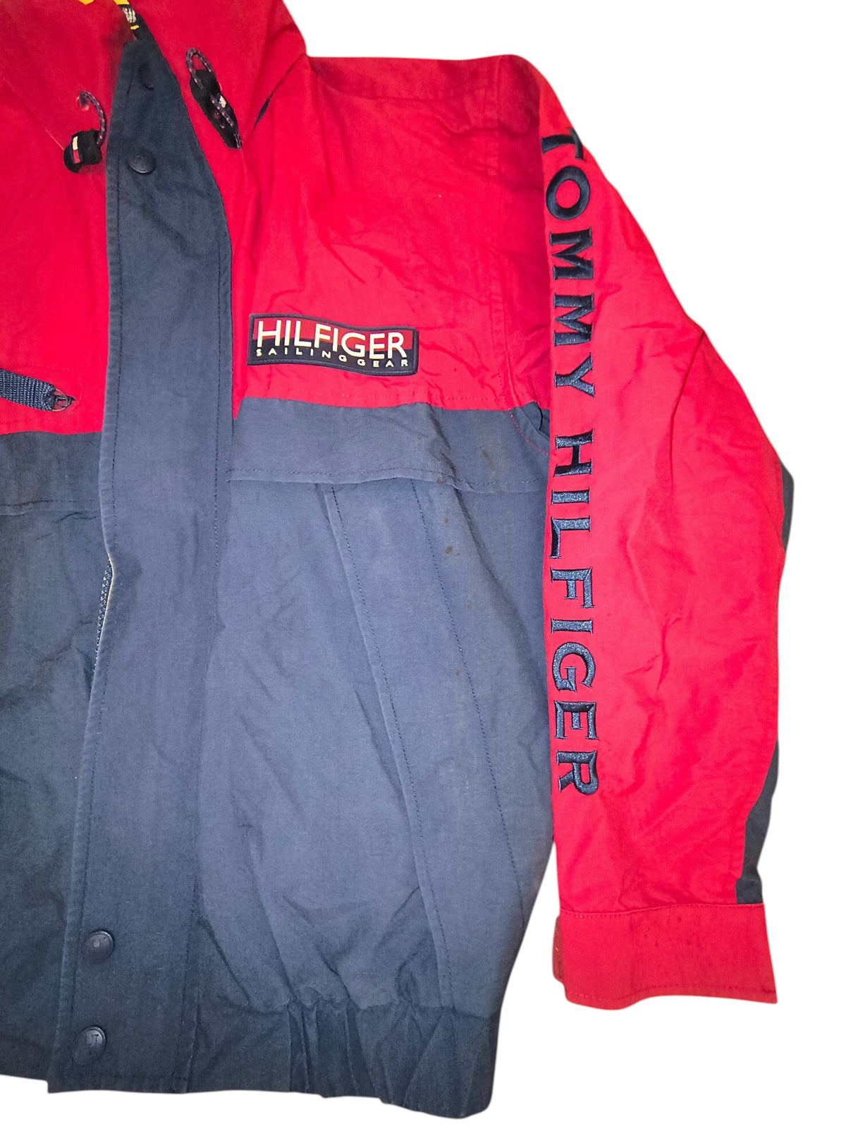 Awsum Thrift vintage Tommy Hilfiger sailing gear jacket in red and navy blue with a hideaway hood and logo detailing.