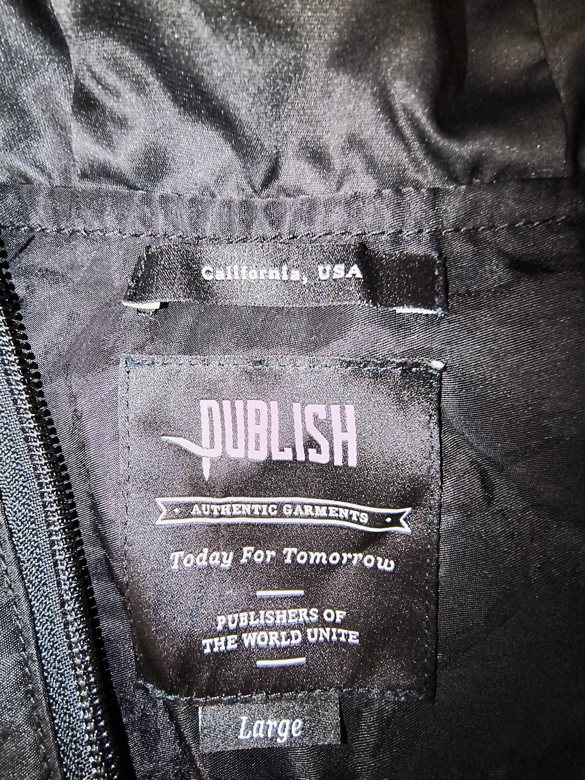 Awsum Thrift Publish Brand black jacket interior label showing size large and California USA branding