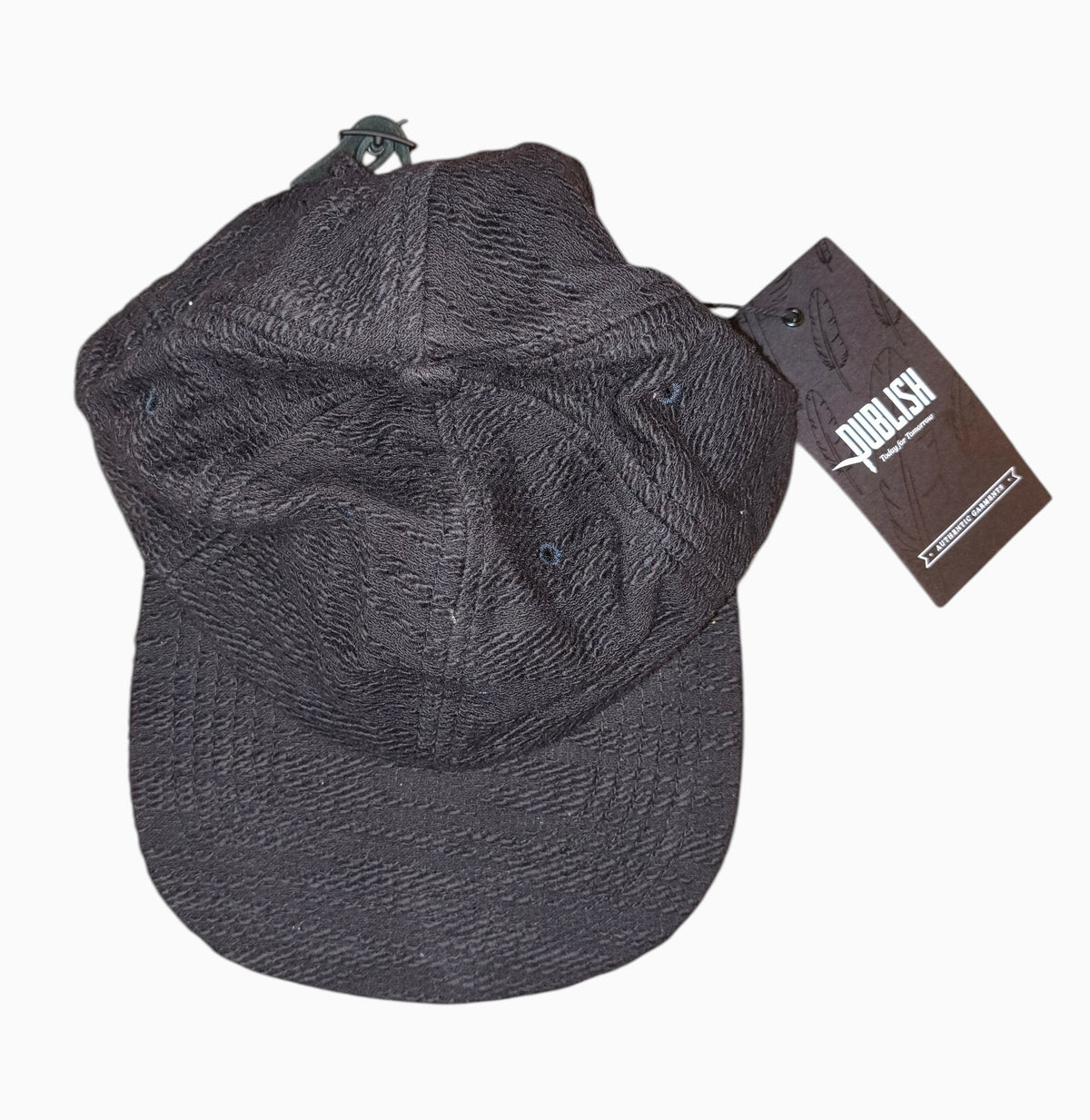 Awsum Thrift Publish Brand Davin black textured 5-panel camper hat with adjustable leather strapback and retail tag