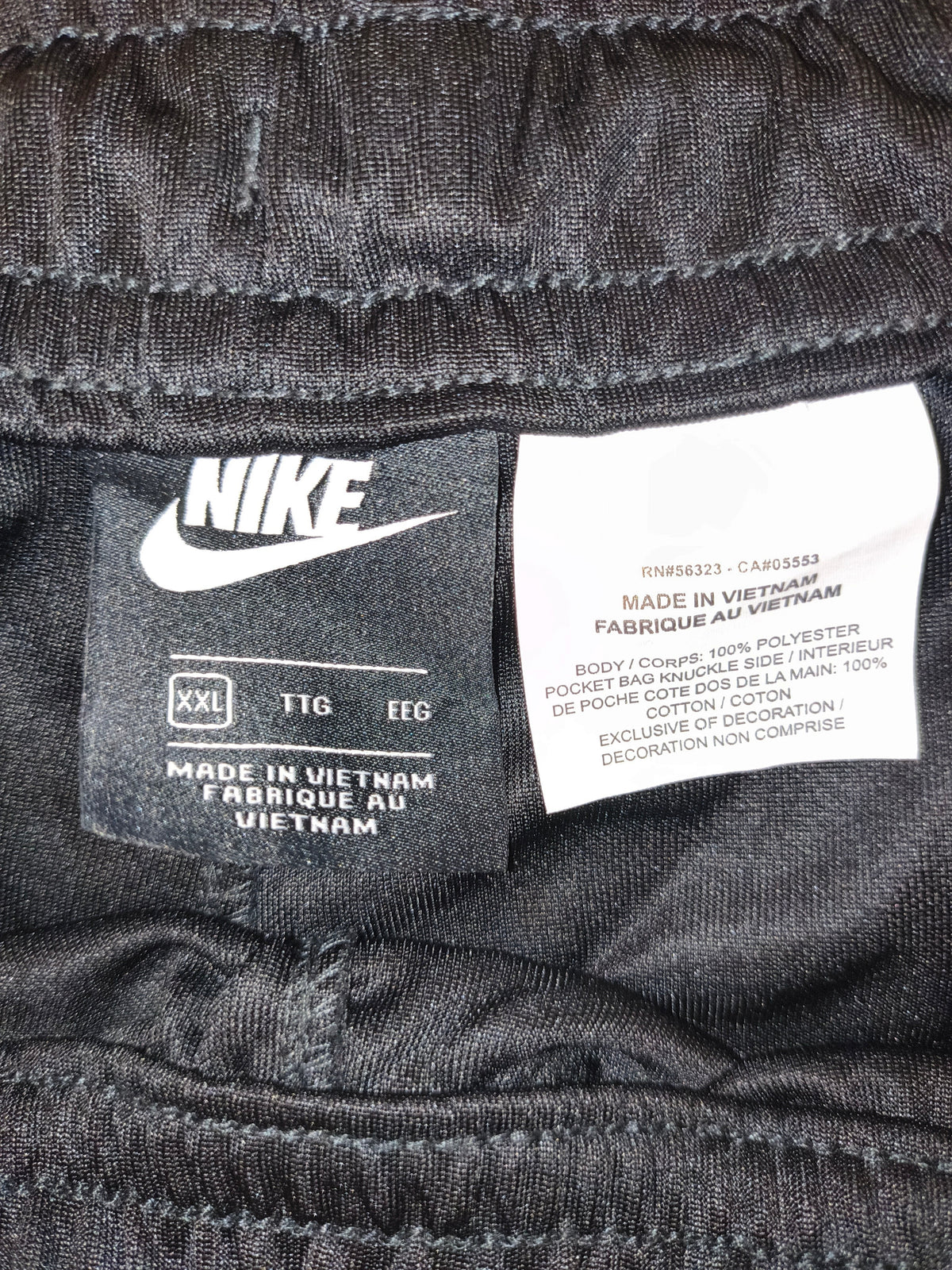 Awsum Thrift black Nike polyester pants interior care label showing size XXL and Vietnam manufacturing details