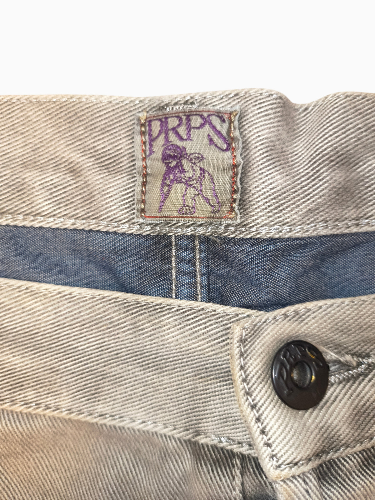 Awsum Thrift PRPS gray denim jeans featuring a branded waist patch with purple logo and dark metal button detail