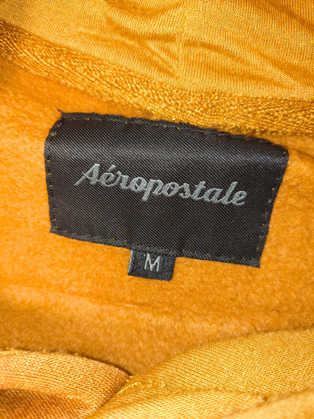 Awsum Thrift Aeropostale hoodie clothing label in dark brown with silver embroidery and size M tag