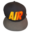 Awsum Thrift vintage Nike Air snapback hat with black crown, grey visor, and yellow-to-orange gradient AIR embroidery
