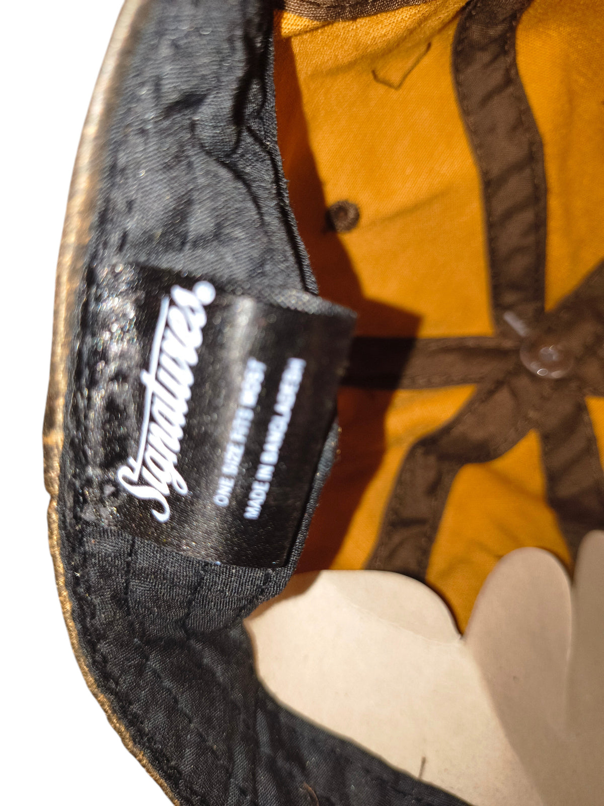 Awsum Thrift Signatures brand label inside a brown distressed faux leather dad hat with interior stitching details